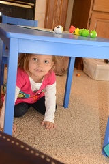 Greta under the table and smiling